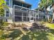 Backyard screened patio with brick and steps at 2874 Bayshore Trails Dr, Tampa, FL 33611