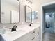 Stylish bathroom with dual sinks, white cabinets, black hardware, and sleek mirrors, offering a contemporary design at 2874 Bayshore Trails Dr, Tampa, FL 33611
