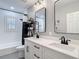 Modern bathroom featuring dual sinks, white cabinets, matte black hardware, and a tiled shower/tub combo at 2874 Bayshore Trails Dr, Tampa, FL 33611