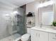 Well-lit bathroom featuring a glass-enclosed shower, white vanity, and decorative towels at 2874 Bayshore Trails Dr, Tampa, FL 33611