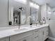 Ensuite bathroom features a double sink vanity with white cabinets and quartz countertops at 2874 Bayshore Trails Dr, Tampa, FL 33611