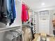 A modern walk-in closet with custom shelving, hanging racks, and a central ottoman at 2874 Bayshore Trails Dr, Tampa, FL 33611
