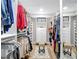 Spacious walk-in closet with custom shelving, storage, and a central ottoman for convenience at 2874 Bayshore Trails Dr, Tampa, FL 33611