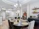 Dining area showcasing wood floors, a chandelier, and a view into the kitchen at 2874 Bayshore Trails Dr, Tampa, FL 33611
