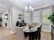 Cozy dining room featuring a chandelier, window shutters, and wood flooring at 2874 Bayshore Trails Dr, Tampa, FL 33611
