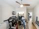 Bright exercise room with workout equipment, desk space, and ceiling fan with home office in background at 2874 Bayshore Trails Dr, Tampa, FL 33611