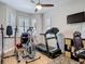 Exercise room with treadmill, elliptical machine, and natural light from shuttered windows at 2874 Bayshore Trails Dr, Tampa, FL 33611