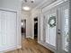 Bright foyer featuring wood flooring, shaker doors, and a view to the exercise room at 2874 Bayshore Trails Dr, Tampa, FL 33611