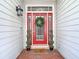 Inviting front door with wreath, sidelights and decorative plants on a brick porch at 2874 Bayshore Trails Dr, Tampa, FL 33611