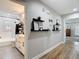 Hallway showcasing modern floating shelves, stylish decor, and leading into a well-appointed bathroom and living space at 2874 Bayshore Trails Dr, Tampa, FL 33611