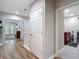 Upstairs hallway with wood floors, white railing and access to the laundry room at 2874 Bayshore Trails Dr, Tampa, FL 33611