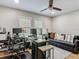 Bright home office space with a ceiling fan, multiple monitors, and comfortable sitting area at 2874 Bayshore Trails Dr, Tampa, FL 33611