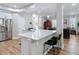 Open kitchen with a center island, stainless steel refrigerator, and a view into the living area at 2874 Bayshore Trails Dr, Tampa, FL 33611