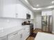 Stylish kitchen with white cabinetry, stainless steel appliances, and a breakfast bar area at 2874 Bayshore Trails Dr, Tampa, FL 33611