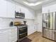 Modern kitchen featuring white cabinets, stainless steel appliances, subway tile backsplash, and quartz countertops at 2874 Bayshore Trails Dr, Tampa, FL 33611