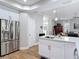 Bright kitchen with stainless steel appliances, an island with bar seating, and white cabinets at 2874 Bayshore Trails Dr, Tampa, FL 33611