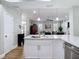Spacious kitchen featuring hardwood flooring, white cabinetry, and stainless steel dishwasher at 2874 Bayshore Trails Dr, Tampa, FL 33611