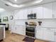 Modern kitchen featuring white cabinetry, stainless steel appliances, and subway tile backsplash at 2874 Bayshore Trails Dr, Tampa, FL 33611