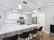 Modern kitchen with white cabinets, quartz countertops, stainless steel appliances, and bar seating at 2874 Bayshore Trails Dr, Tampa, FL 33611