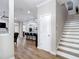 Open concept living area featuring wood flooring, staircase, and modern lighting at 2874 Bayshore Trails Dr, Tampa, FL 33611
