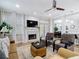Comfortable living room featuring a fireplace, media center, and an open floor plan to the dining area at 2874 Bayshore Trails Dr, Tampa, FL 33611