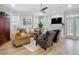 Bright living room with hardwood floors, fireplace, modern ceiling fan, and comfortable seating at 2874 Bayshore Trails Dr, Tampa, FL 33611