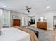 Bright main bedroom features a ceiling fan, access to a sitting room, and wood-look flooring at 2874 Bayshore Trails Dr, Tampa, FL 33611