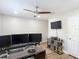 Bright office featuring a ceiling fan, wood floors, modern desk, and multiple monitors for a functional workspace at 2874 Bayshore Trails Dr, Tampa, FL 33611