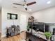 Bright office with multiple monitors, shelving, and a ceiling fan, creating a comfortable and productive work environment at 2874 Bayshore Trails Dr, Tampa, FL 33611