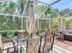 Outdoor patio with dining table and umbrella for shade in a screened lanai at 2874 Bayshore Trails Dr, Tampa, FL 33611
