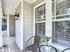 Charming outdoor seating with a small table adjacent to large windows and siding at 2874 Bayshore Trails Dr, Tampa, FL 33611