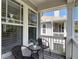 Cozy outdoor seating area with small table and chairs on a covered porch for relaxing at 2874 Bayshore Trails Dr, Tampa, FL 33611
