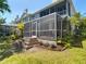 Enjoy outdoor living on this home's screened porch with brick steps and well-manicured landscaping at 2874 Bayshore Trails Dr, Tampa, FL 33611