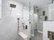 A contemporary glass shower features a built in seat and niche with a hand held shower fixture at 2874 Bayshore Trails Dr, Tampa, FL 33611