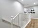 Staircase featuring white railings and wood flooring with decorative shelving at 2874 Bayshore Trails Dr, Tampa, FL 33611