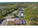 Aerial view showcasing homes with screened pools, lush landscaping, and tree-lined streets at 3109 Tarpon Woods Blvd, Palm Harbor, FL 34685
