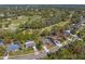 Scenic view of golf course community, featuring lush green fairways meandering through homes and trees at 3109 Tarpon Woods Blvd, Palm Harbor, FL 34685
