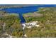 Expansive aerial view of boat launch and a beautiful lake surrounded by verdant trees and waterways at 3109 Tarpon Woods Blvd, Palm Harbor, FL 34685