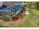 Inviting screened pool area with lush landscaping, perfect for outdoor entertaining and relaxation at 3109 Tarpon Woods Blvd, Palm Harbor, FL 34685