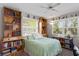 Inviting bedroom featuring built-in bookcases, natural light, and a cozy, comfortable atmosphere at 3109 Tarpon Woods Blvd, Palm Harbor, FL 34685