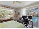 Bedroom with a work-from-home setup and views of the lanai and pool at 3109 Tarpon Woods Blvd, Palm Harbor, FL 34685