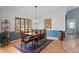Dining room with wood table, six chairs, chandelier, and bright windows at 3109 Tarpon Woods Blvd, Palm Harbor, FL 34685