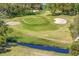 Scenic aerial view of a golf course hole with sand traps and a small stream at 3109 Tarpon Woods Blvd, Palm Harbor, FL 34685