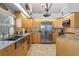 Spacious kitchen with stainless steel appliances, granite countertops, and light wood cabinets at 3109 Tarpon Woods Blvd, Palm Harbor, FL 34685