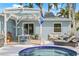 Backyard patio with comfortable seating area, dining table, and grill, ideal for outdoor gatherings at 330 47Th N Ave, St Petersburg, FL 33703