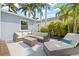Cozy outdoor patio with comfortable seating and lounge chair surrounded by tropical plants at 330 47Th N Ave, St Petersburg, FL 33703