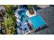Aerial view of a backyard oasis featuring a sparkling pool, lounge area, and lush tropical landscaping at 330 47Th N Ave, St Petersburg, FL 33703