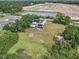 Aerial view of the property featuring a blue two-story home, expansive yard, and neighborhood construction at 4125 89Th E St, Palmetto, FL 34221