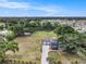Sprawling aerial view showcasing the home's expansive yard, long driveway, detached garage, and surrounding neighborhood at 4125 89Th E St, Palmetto, FL 34221