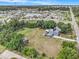 Aerial view of the property featuring a blue two-story home, large yard, and neighborhood pond at 4125 89Th E St, Palmetto, FL 34221